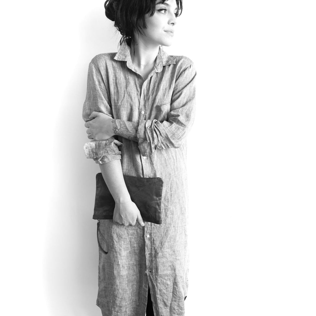 Model with an alex wristet clutch in hand size large shown