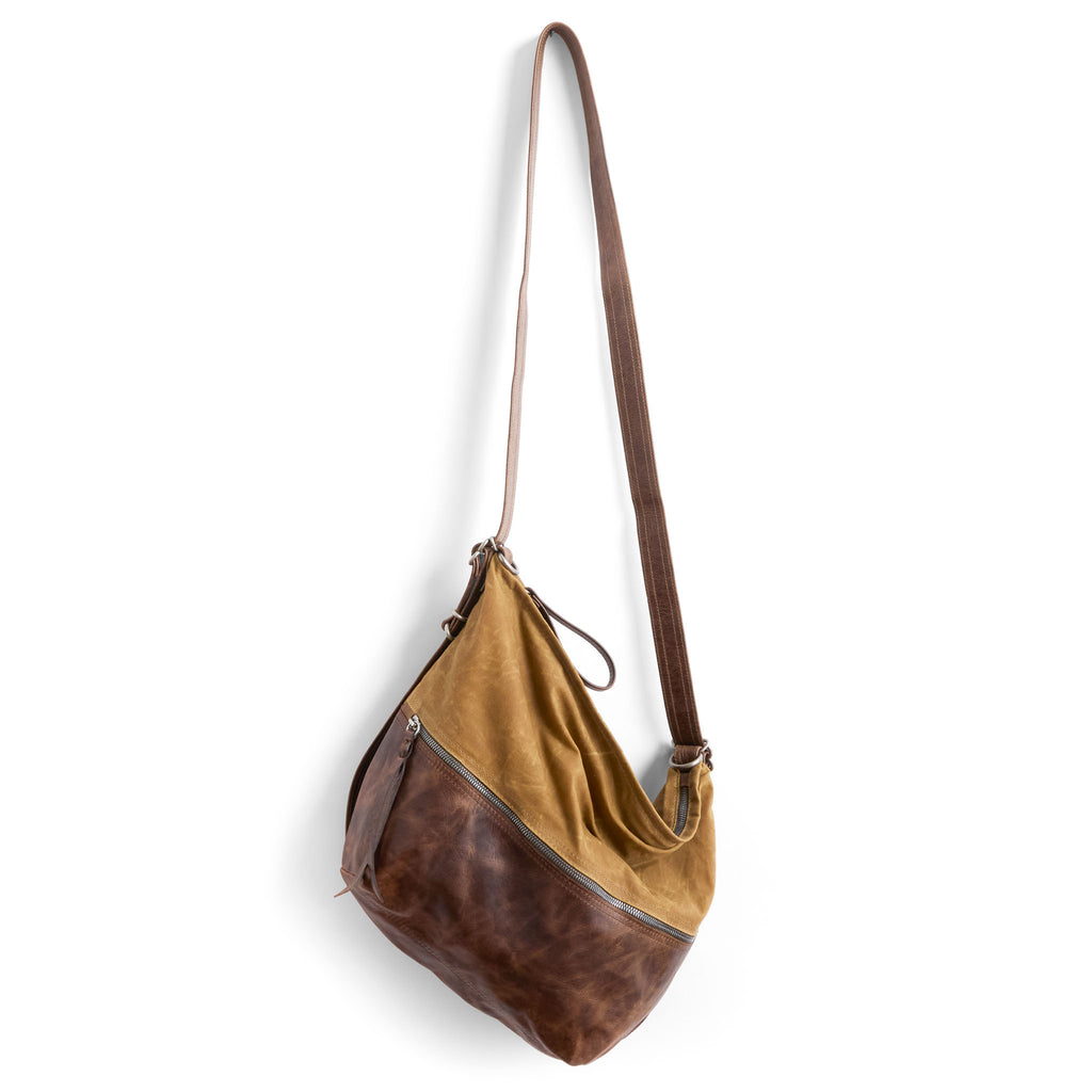 city safari single zip size medium in whiskey waxed canvas and rustic pecan, showcasing extended strap
