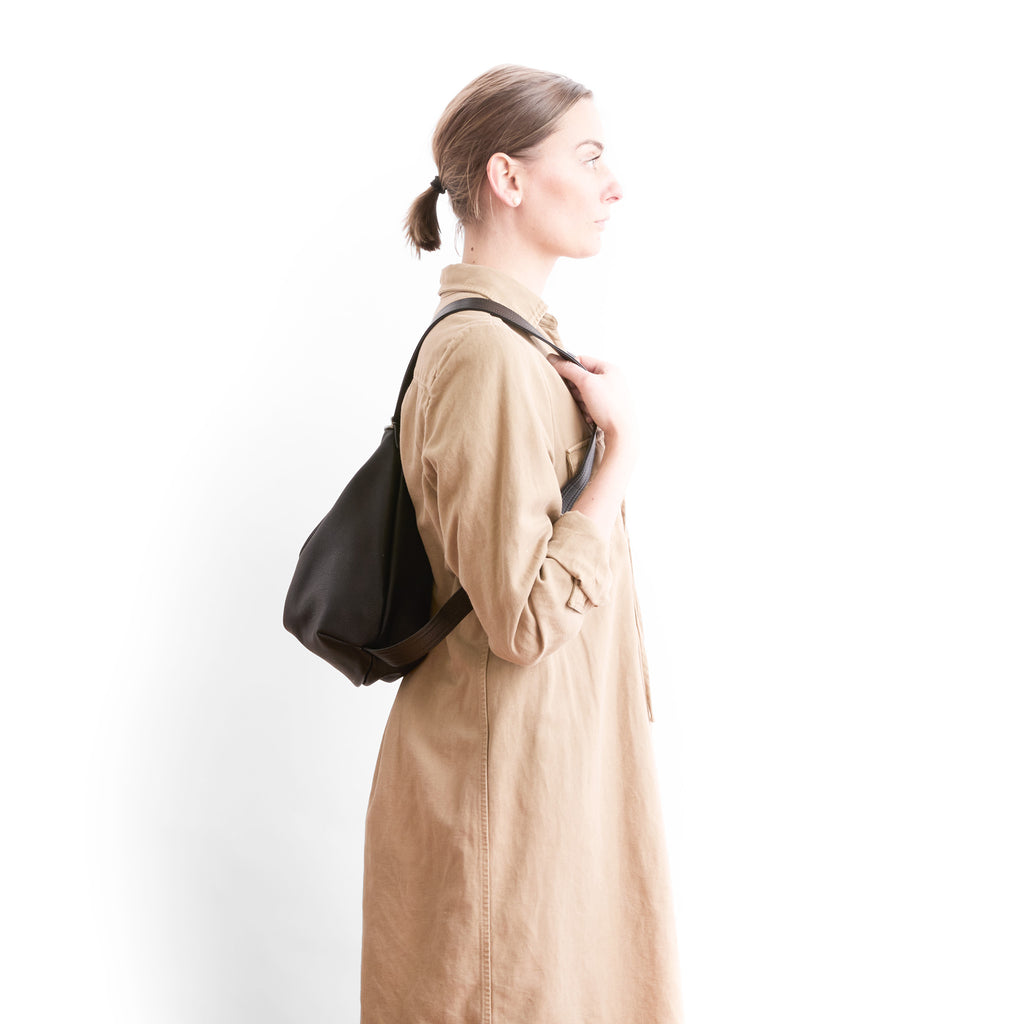 model with duffel medium in nero and black configured as backpack side view