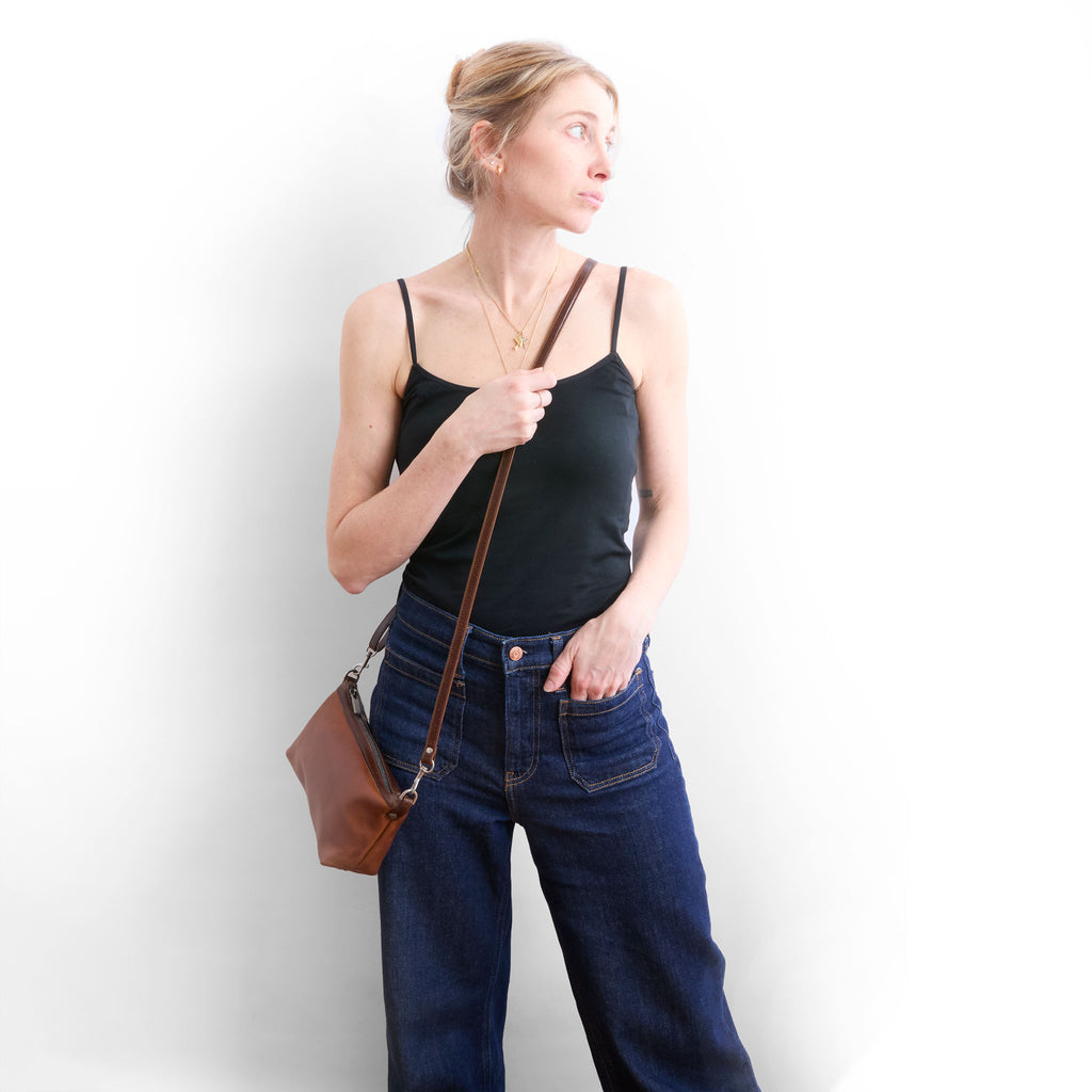 the wren in pure saddle being worn as a crossbody