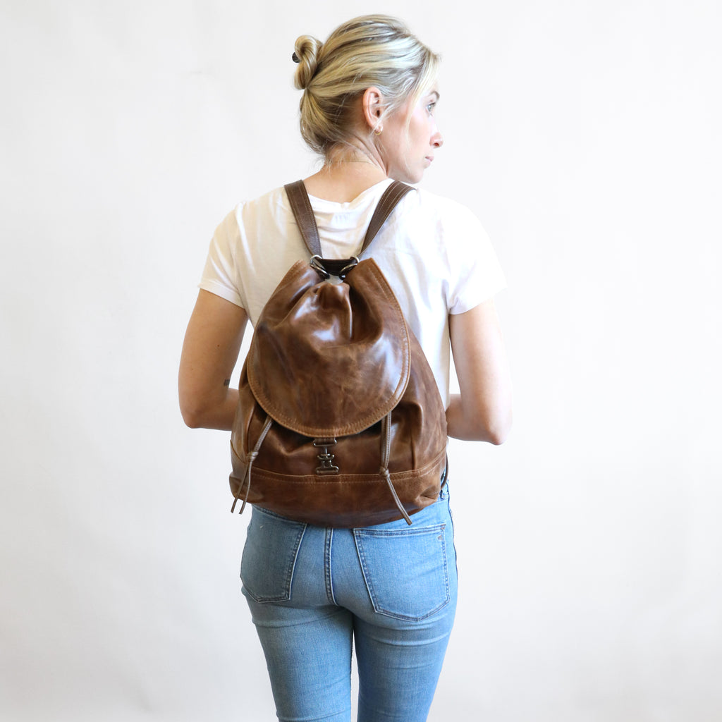 Back view of model wearing 1904 maxwell, size large, as a backpack.