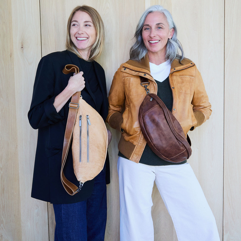 the lissa in flight vachetta on left, showcasing back zippered pockets. the lissa in fuentes on right. 