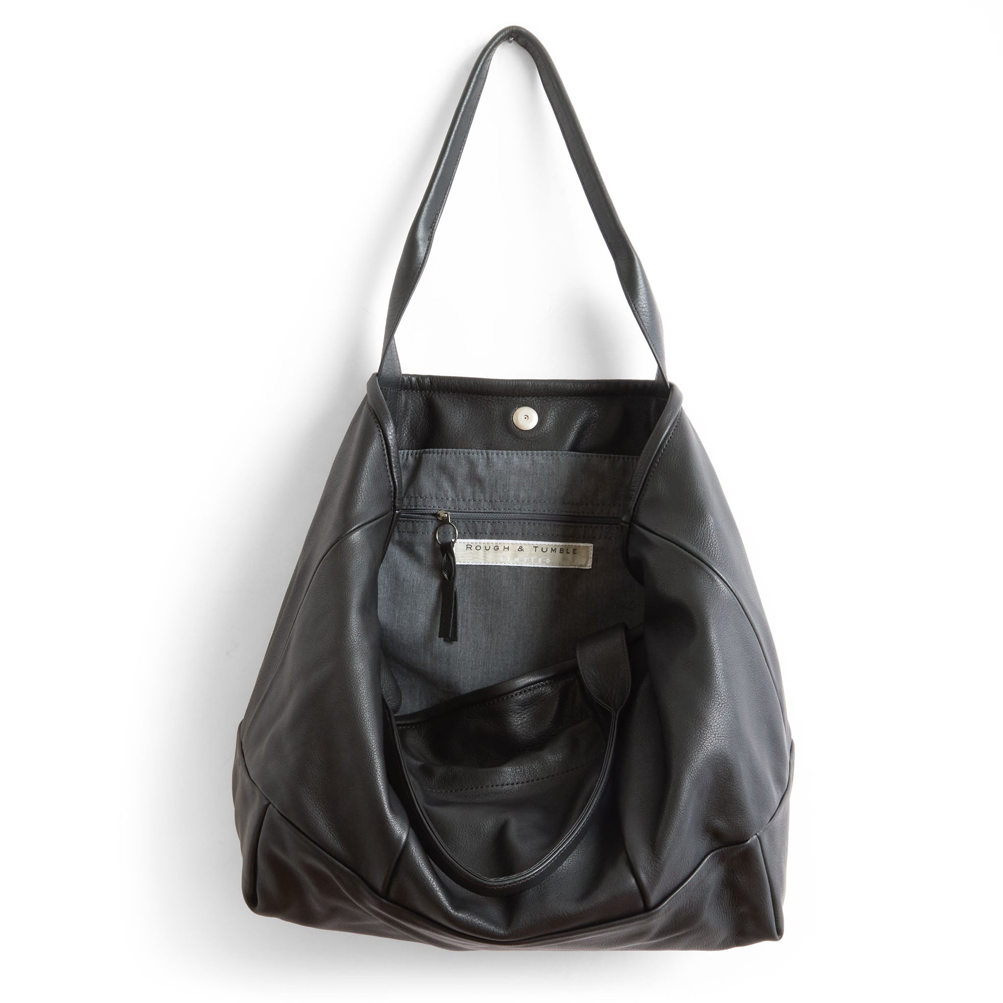 cape asher in nero, showcasing interior grey chambray and zippered interior pocket