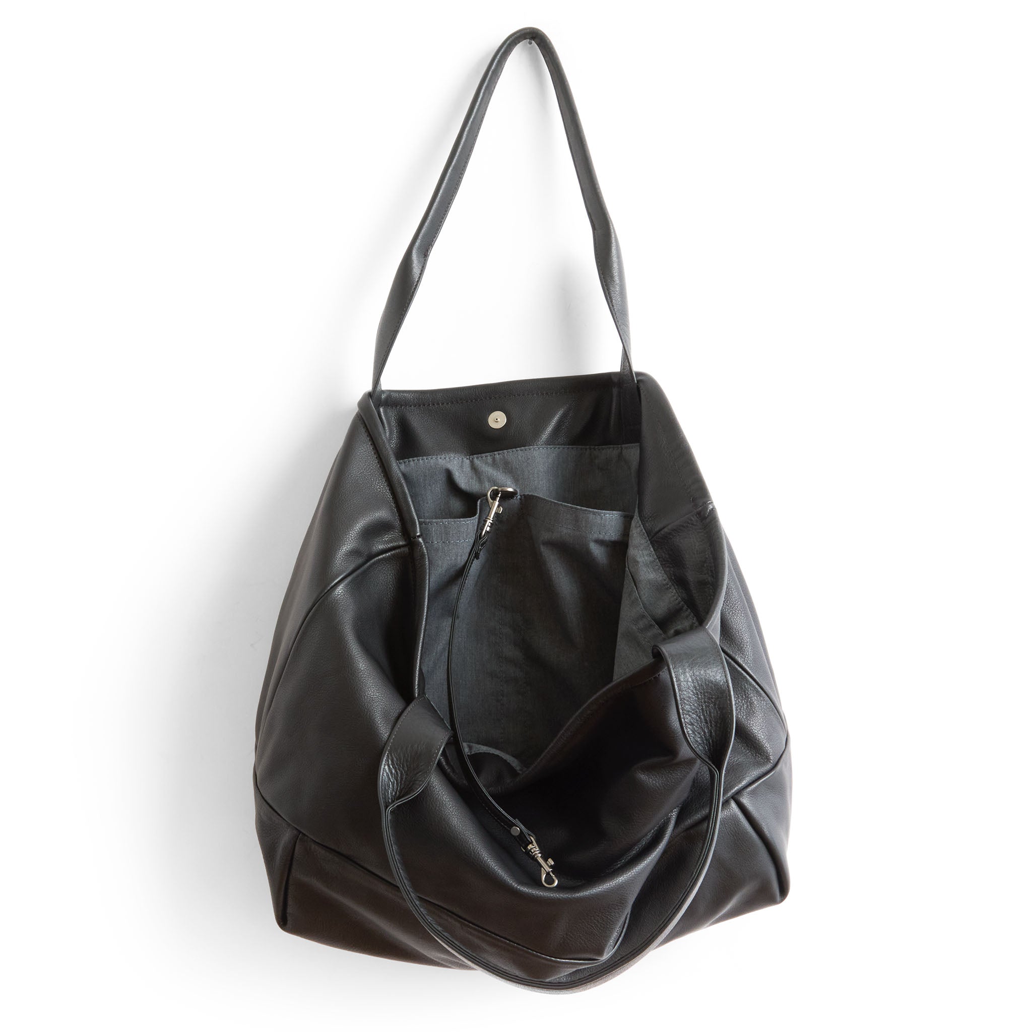 cape asher in nero, showcasing interior grey chambray lining and open pockets