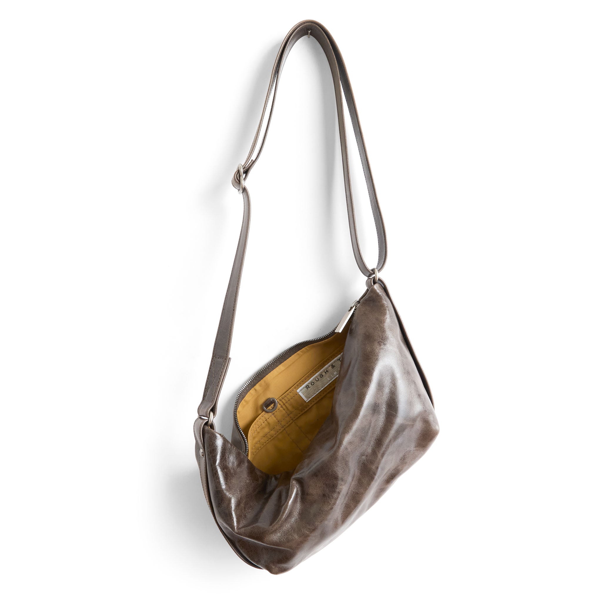 cooper in distressed tusk, showcasing interior bumble lining and open pockets