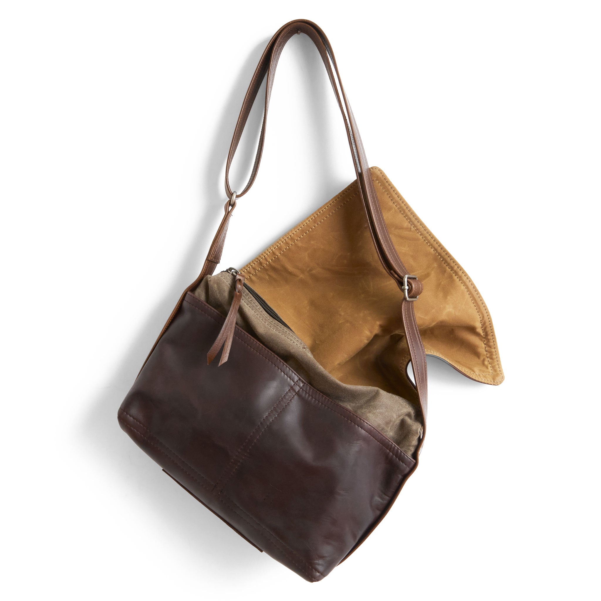 little book bag in pure earth, showcasing interior flap lined in sienna waxed canvas and open pockets