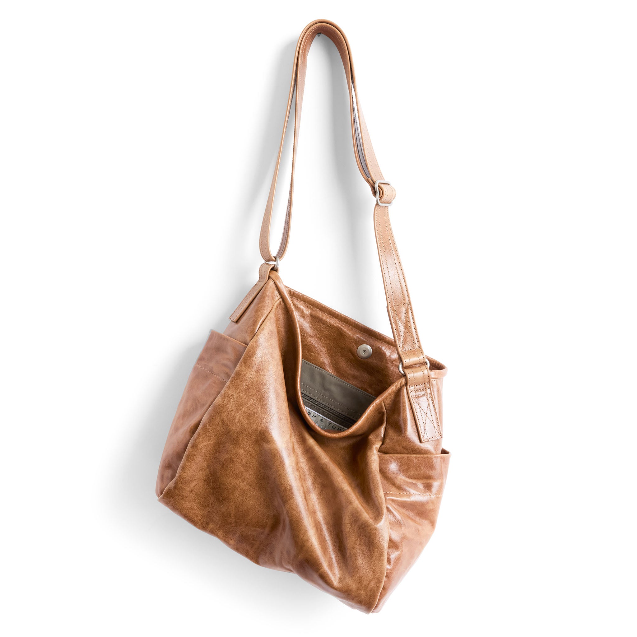 bucket crossbody in light saddle, showcasing interior essex lining and zippered pocket