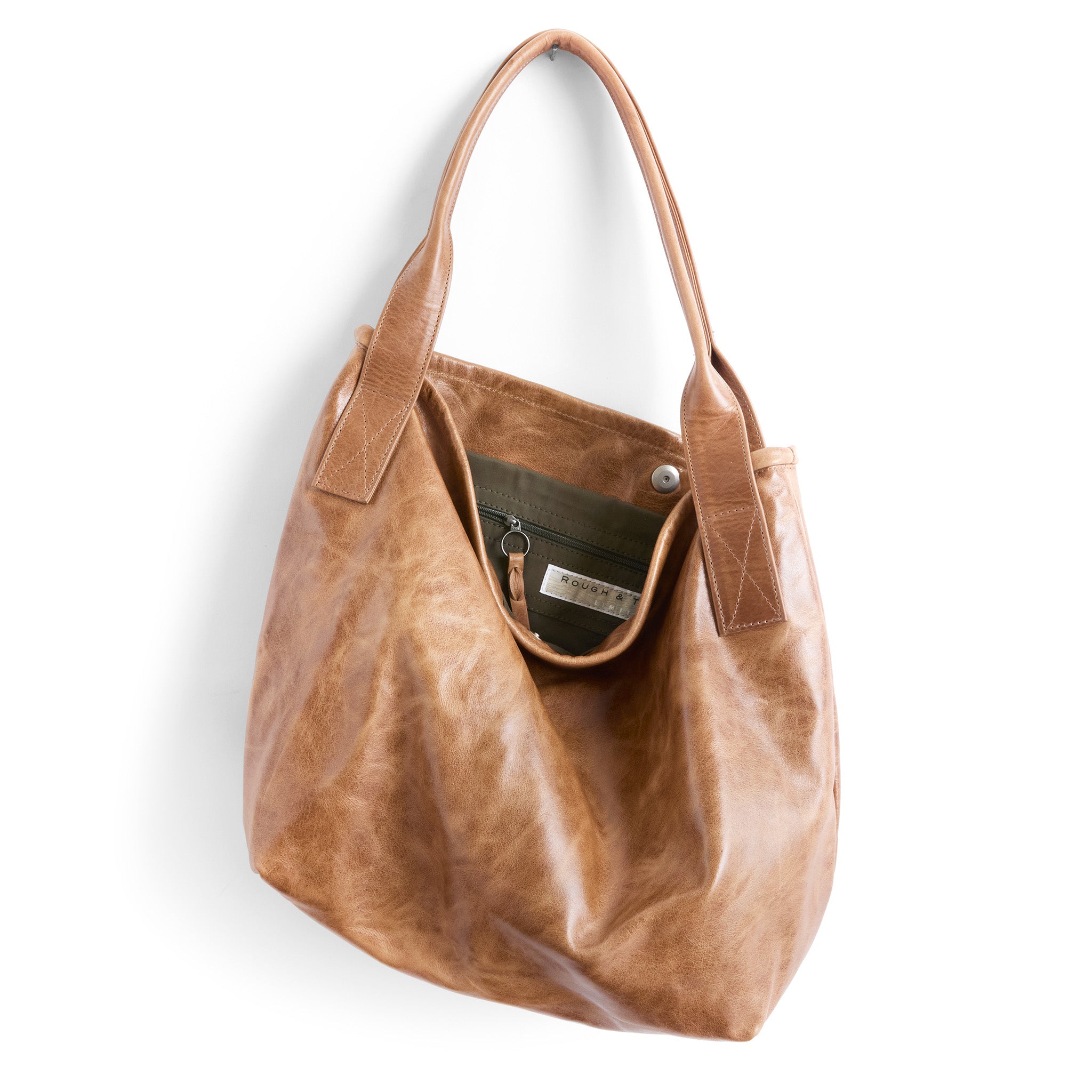 tyler size large in light saddle, showcasing interior kelp lining and zippered pocket