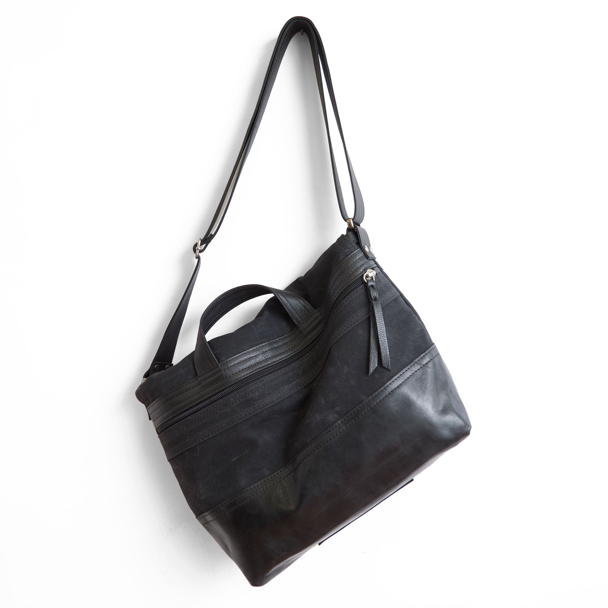 1909 medium in black waxed canvas, showcasing back zippered pocket