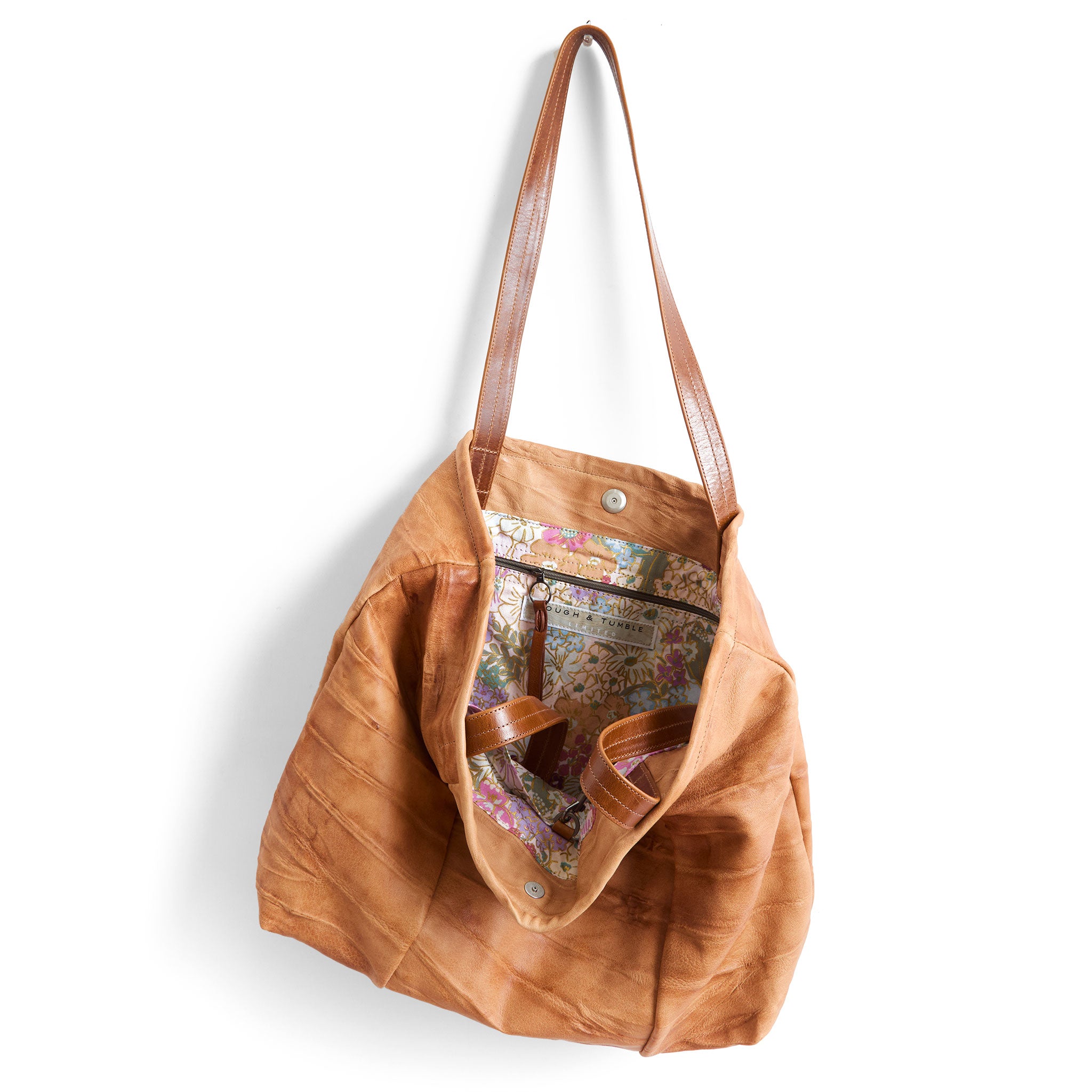 asher size large in milano saddle, showcasing interior rifle paper co. mimi plum lining