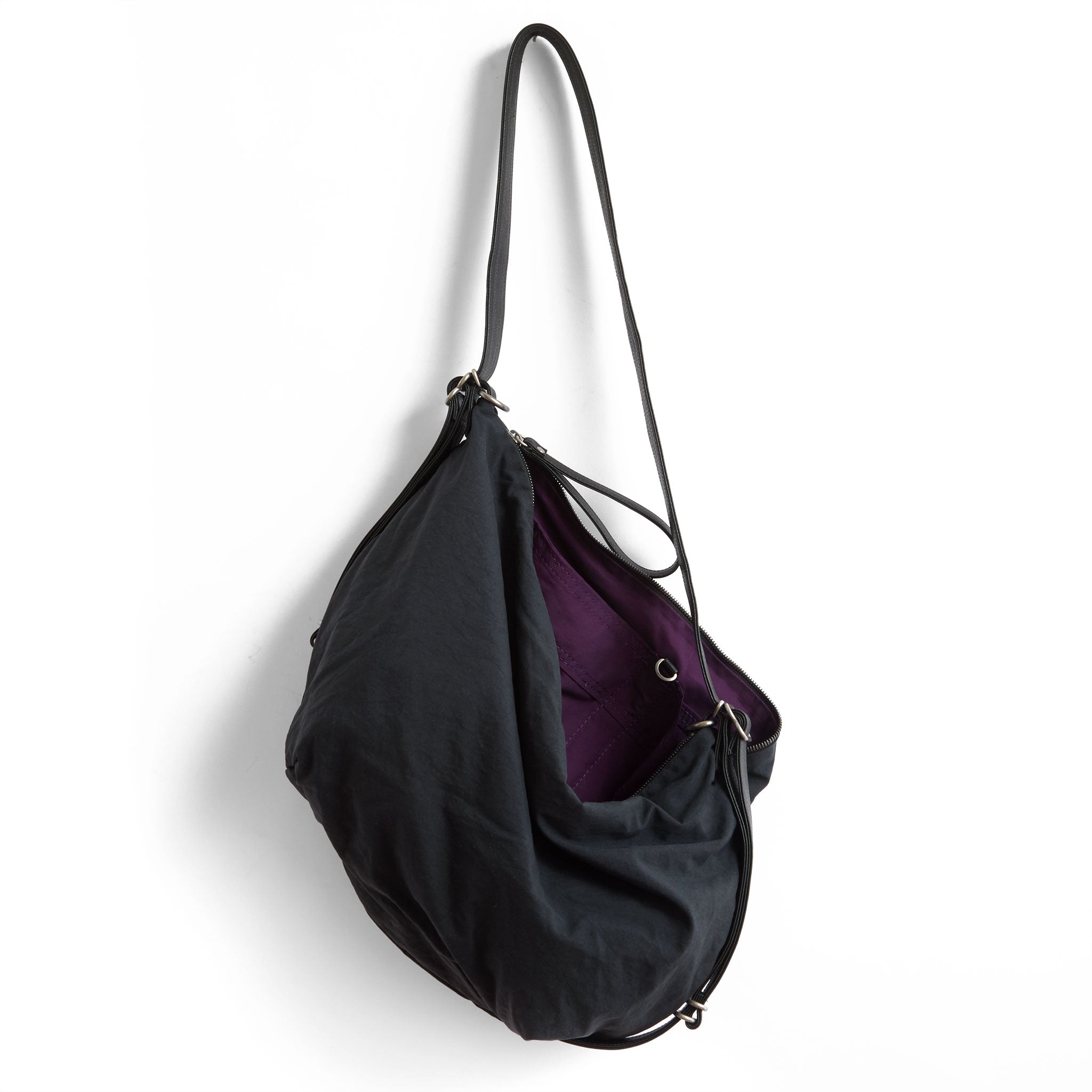 duffel size large in matte black japanese textured canvas, showcasing interior purple lining and open pockets