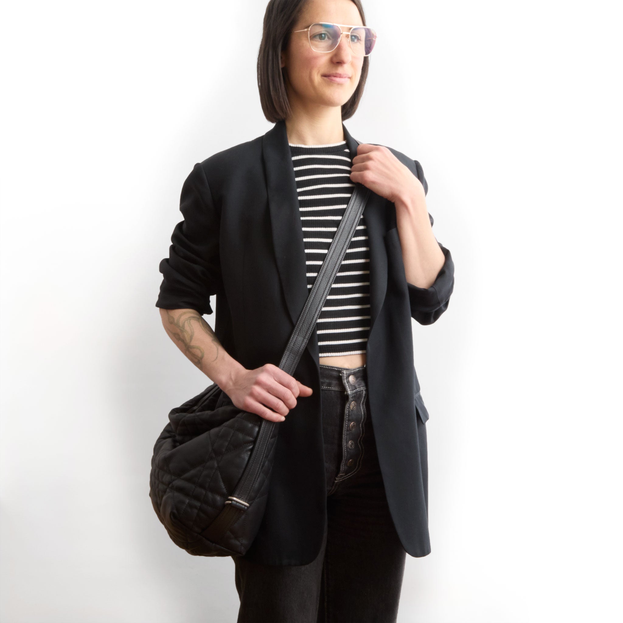 duffel size medium in quilted pashi black, modeled in crossbody setting