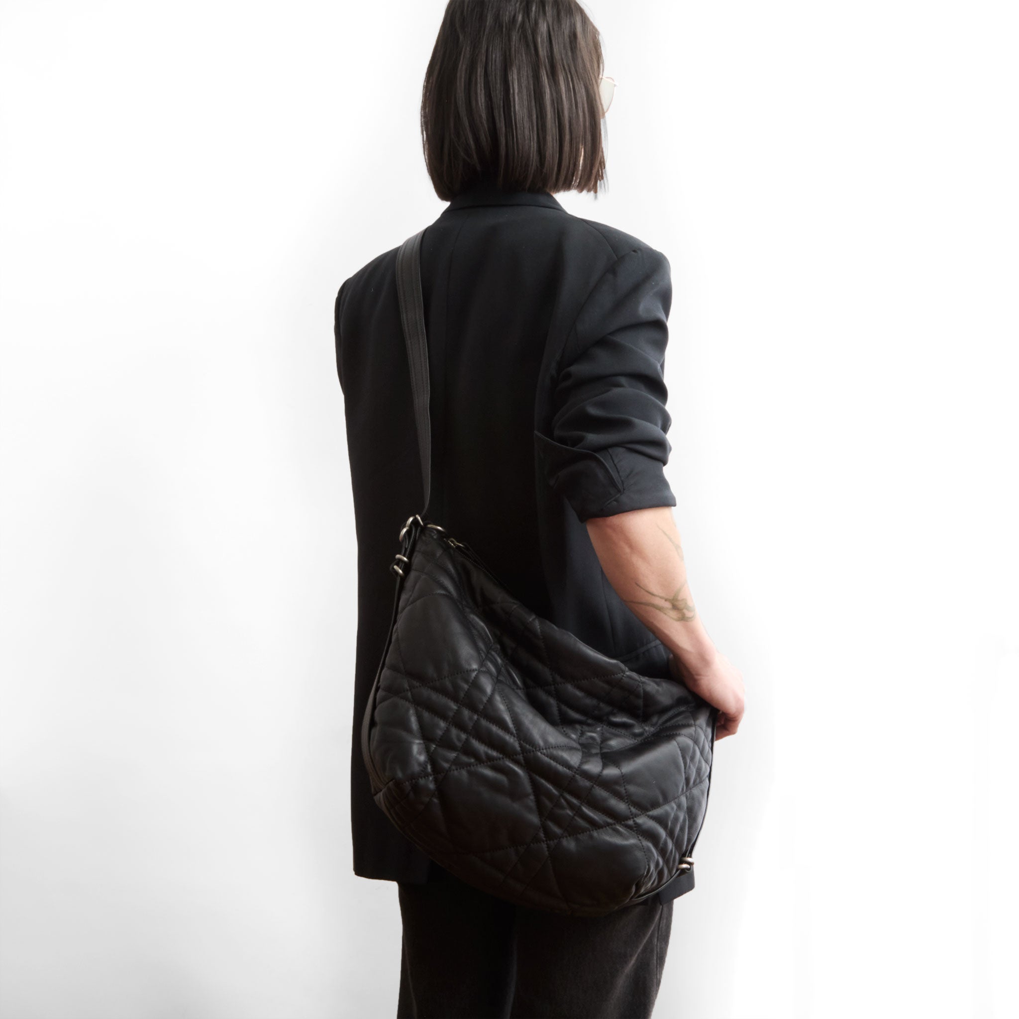duffel size medium in quilted pashi black, modeled in crossbody setting