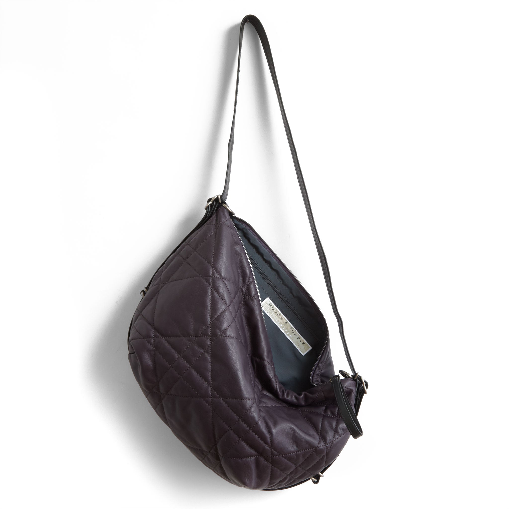 duffel size medium in quilted pashi purple, showcasing interior petrol lining and zippered pocket