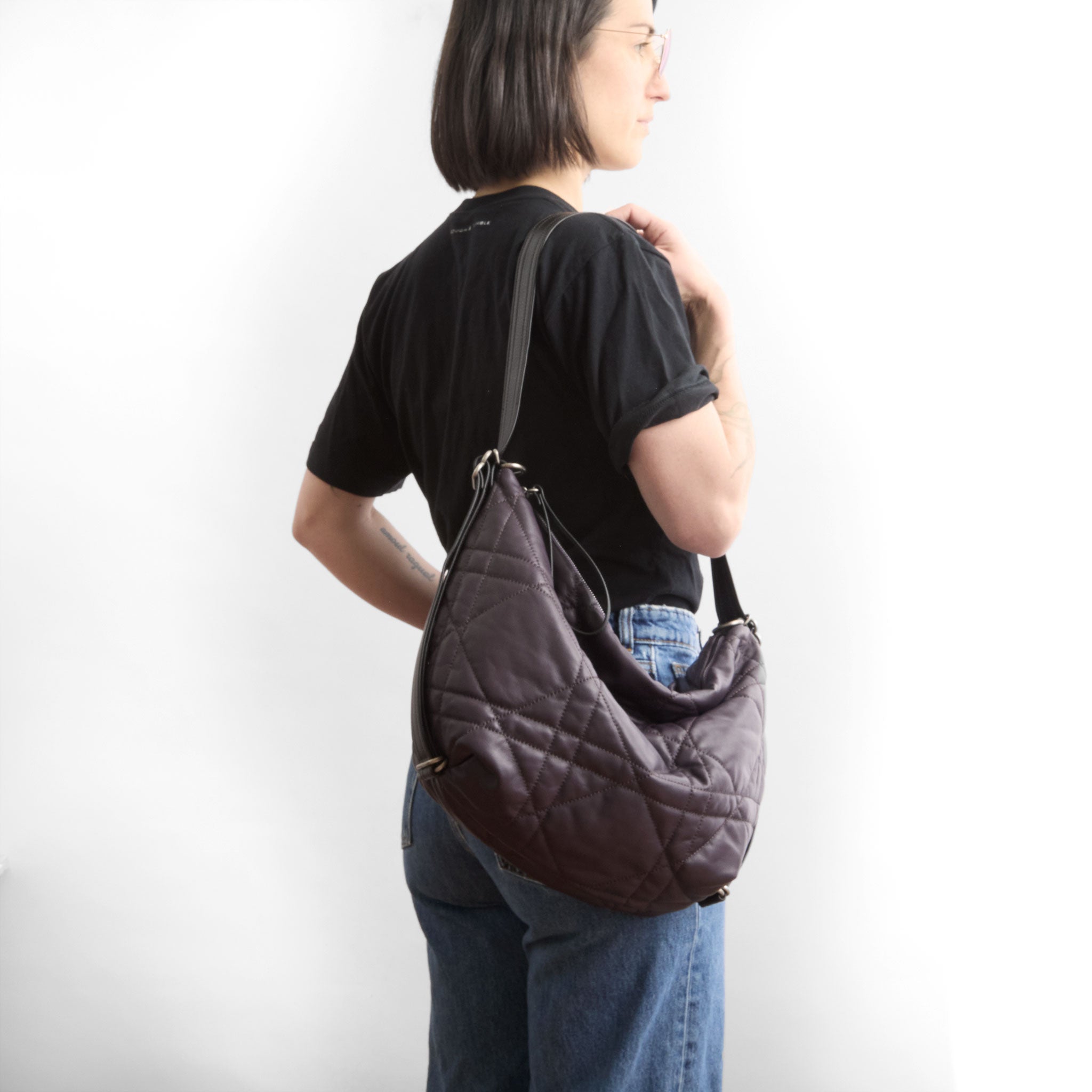 duffel size medium in quilted pashi purple being modeled in shoulder setting