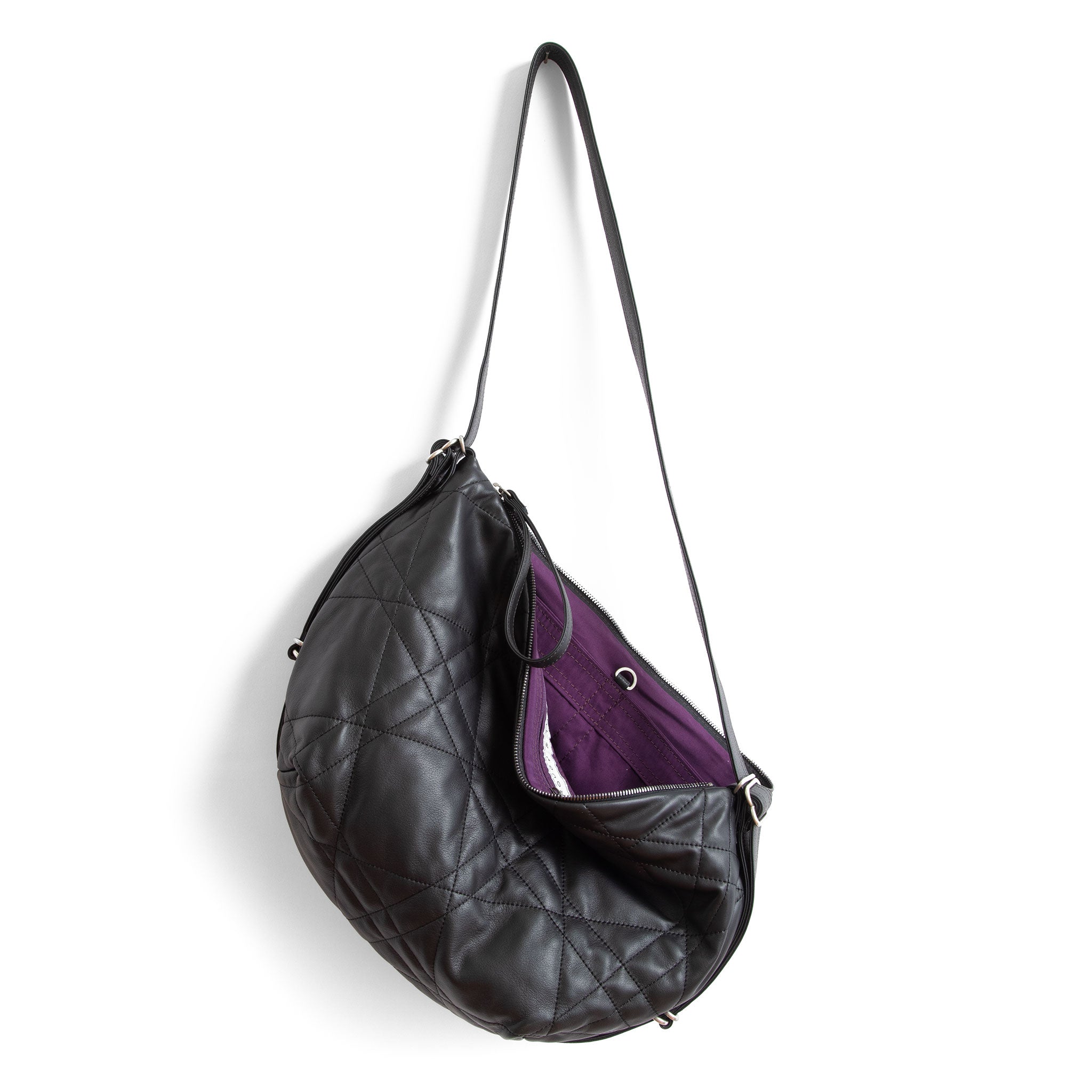 duffel single zip in quilted pashi black, showcasing interior purple lining and open pockets