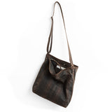 plaid waxed canvas + distressed espresso | lerret in plaid waxed canvas, showcasing interior magnetic closure and phone pocket