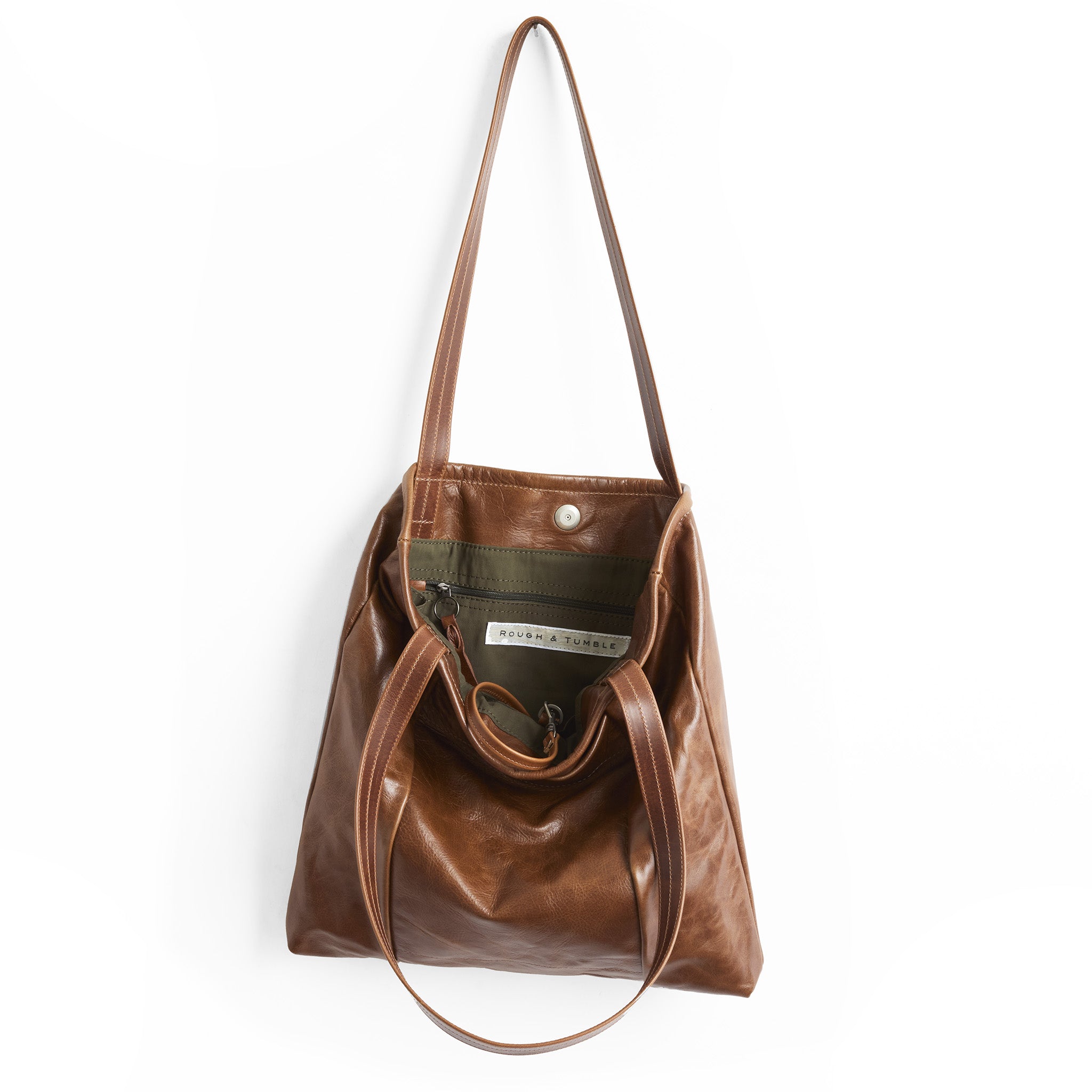 nina tote in saddle, showcasing interior kelp lining