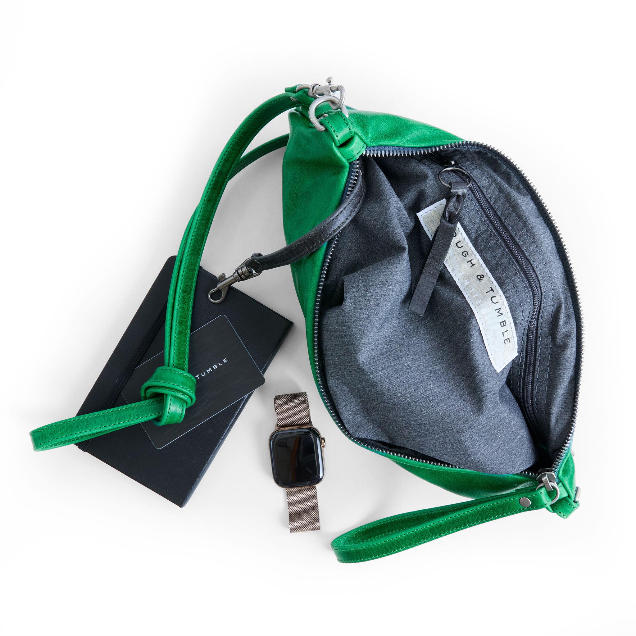 the covet in emerald, showcasing interior grey chambray lining and zippered pocket
