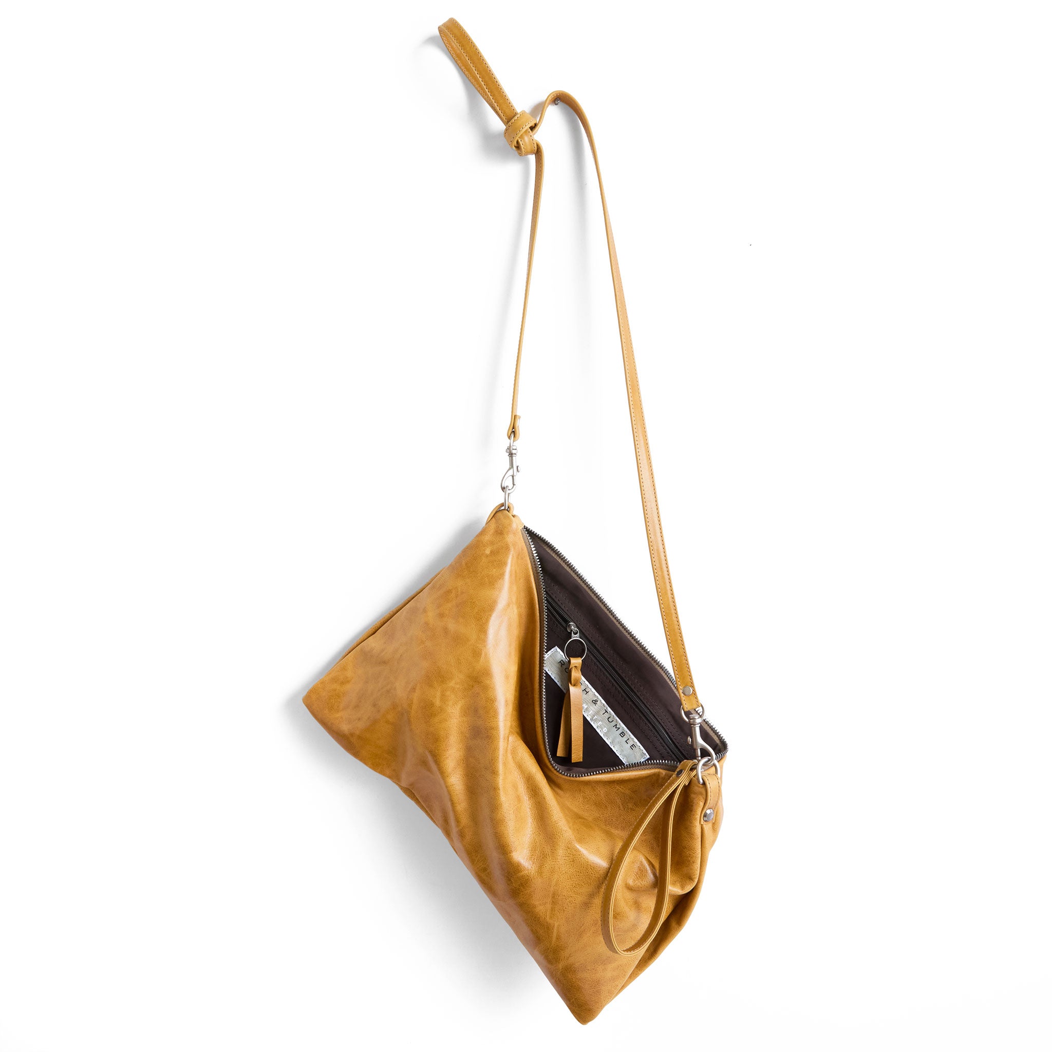 the covet in goldenrod, showcasing interior cocoa lining and zippered pocket