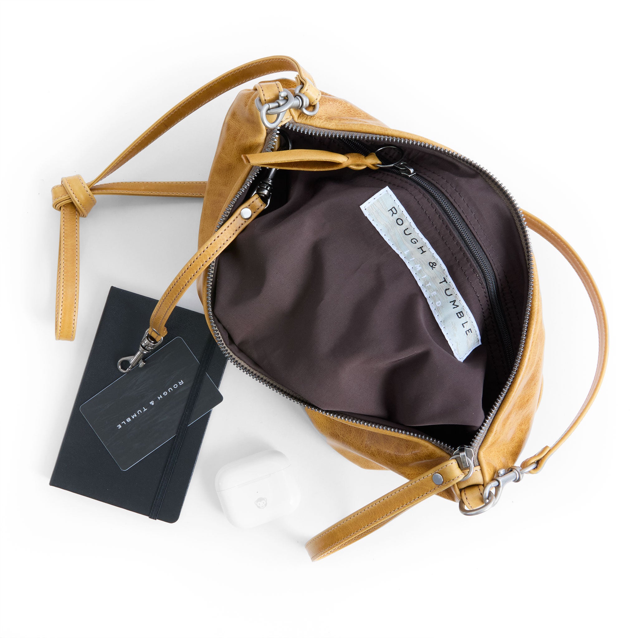 the covet in goldenrod, showcasing interior cocoa lining and zippered pocket