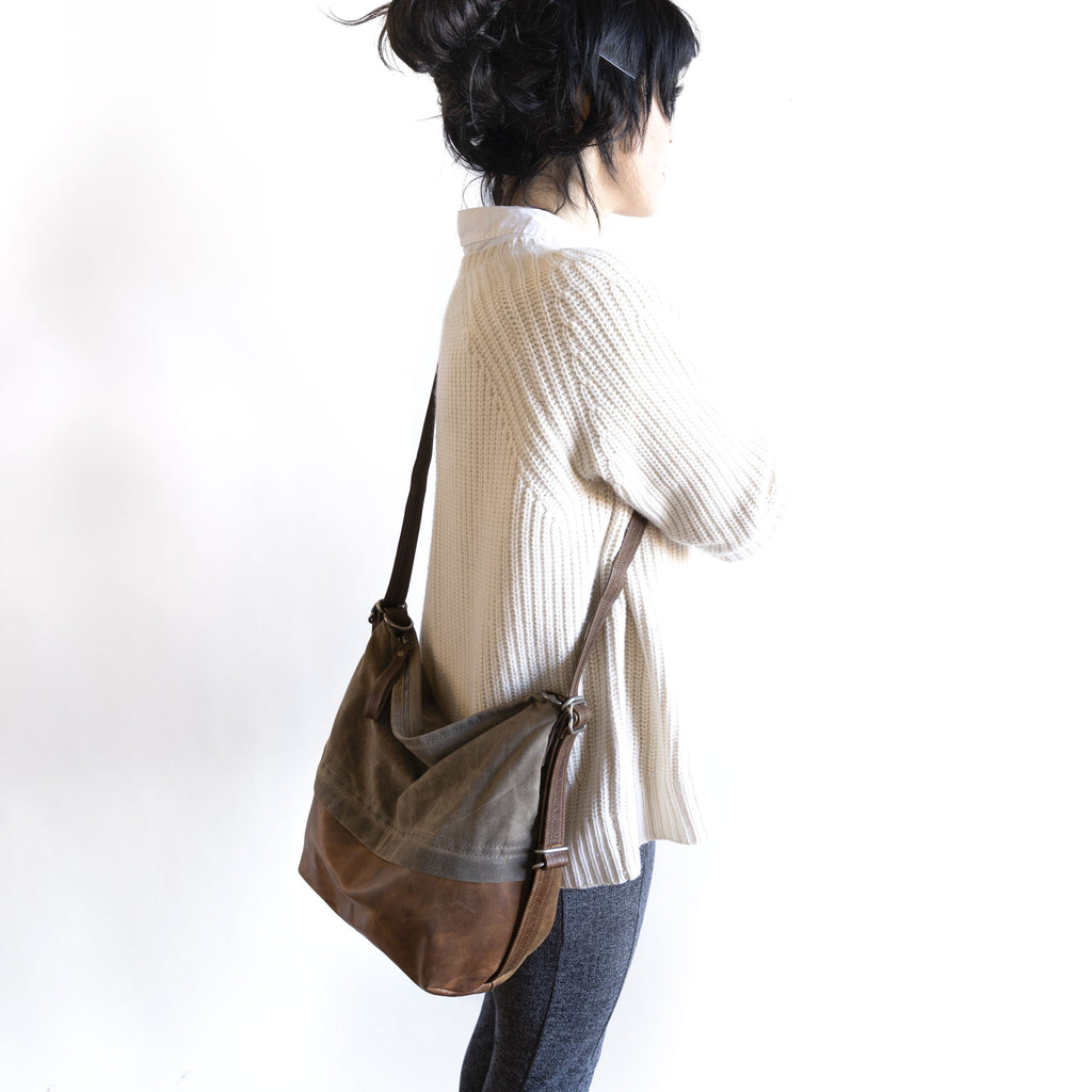 Model wearing an original city safari single zip, size large, crossbody. 