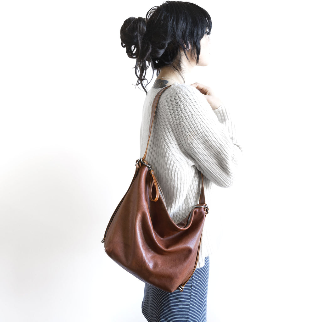 Model with a hobo pack original, size medium, showing strap adjusted to shoulder length. 