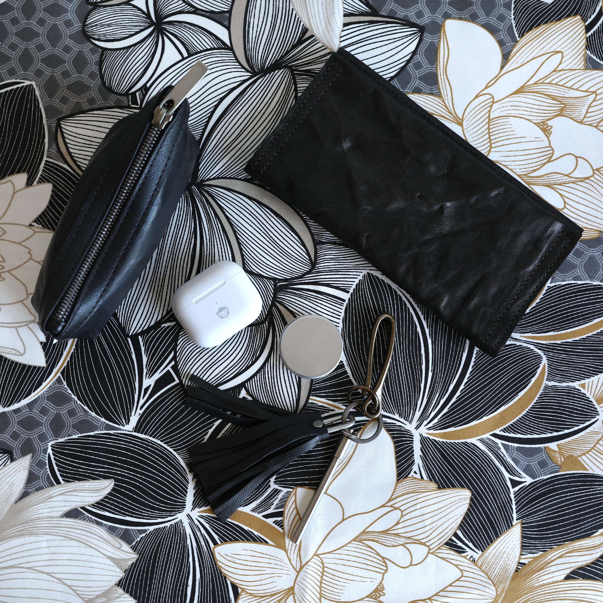 zip pouch with top stripe small in rodeo black with a snap wallet in rodeo black and a key slip tassel